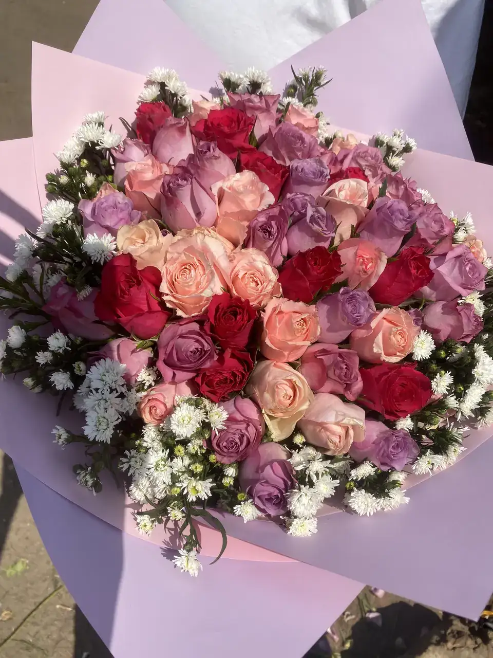 Oversized bouquet of blush, mauve and crimson roses with white accents