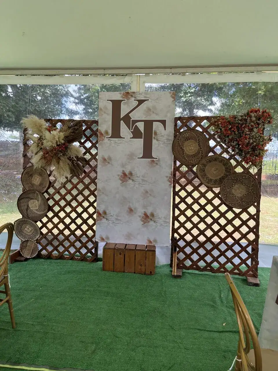 Monogrammed backdrop with lattice screens and dried floral styling